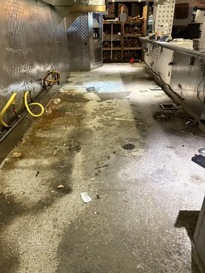 Commercial kitchen floor before coating, stained concrete