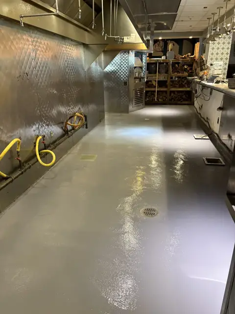 Coated commercial kitchen line floor