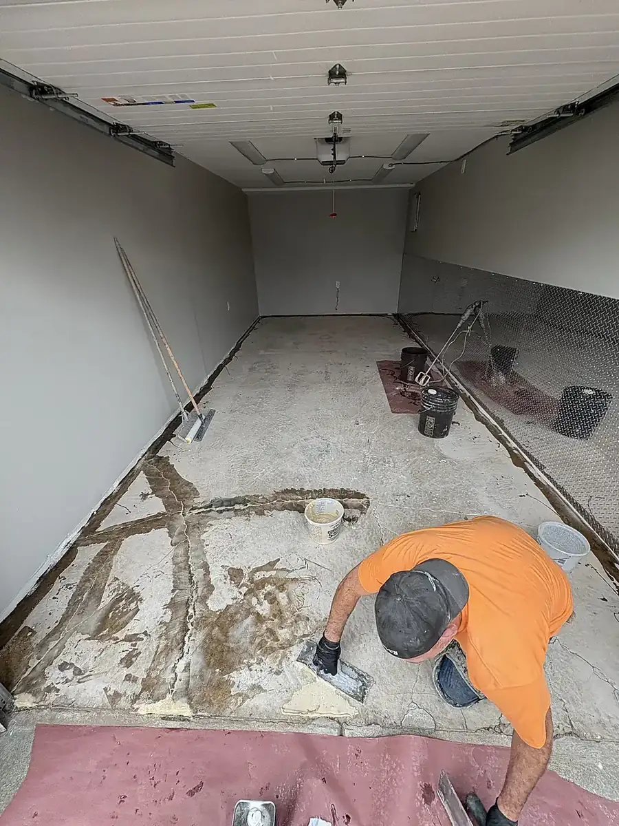 Liberty Epoxy installer hand-patching a concrete floor before coating